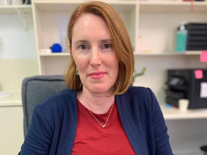 Heather, a woman with blonde hair, smiles into the camera.