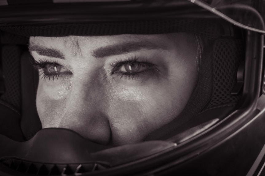 Woman 's eyes through bike helmet.