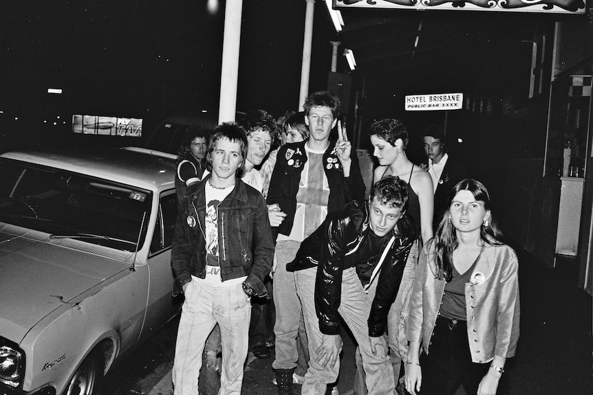 A group of people dressed in punk clothing on the street