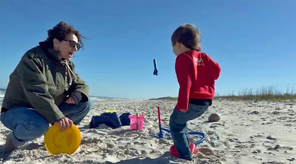 Crew 12 commander Jessica Meir, relaxing with her family on the beach at Cape Canaveral, encourages her three-year-old daughter as she launches an air-propelled toy rocket. / Credit: Jessica Meir