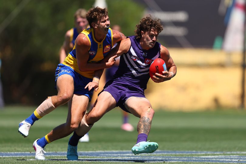Cooper Duff-Tytler of the Eagles tackles Luke Jackson.