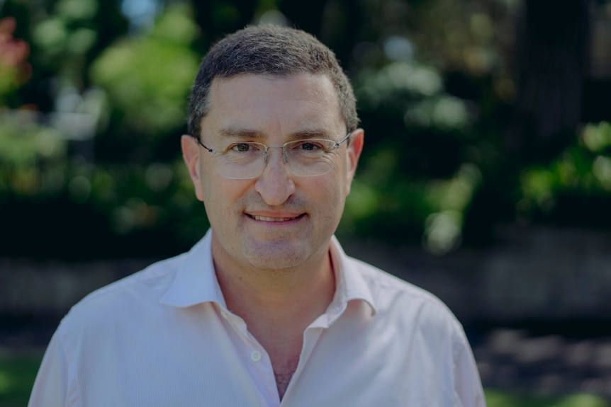 Julian Leeser smiles, wearing a button-up shirt outdoors.