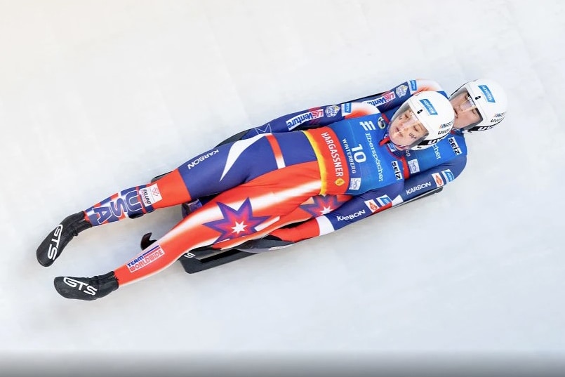 Two women on a sled on ice