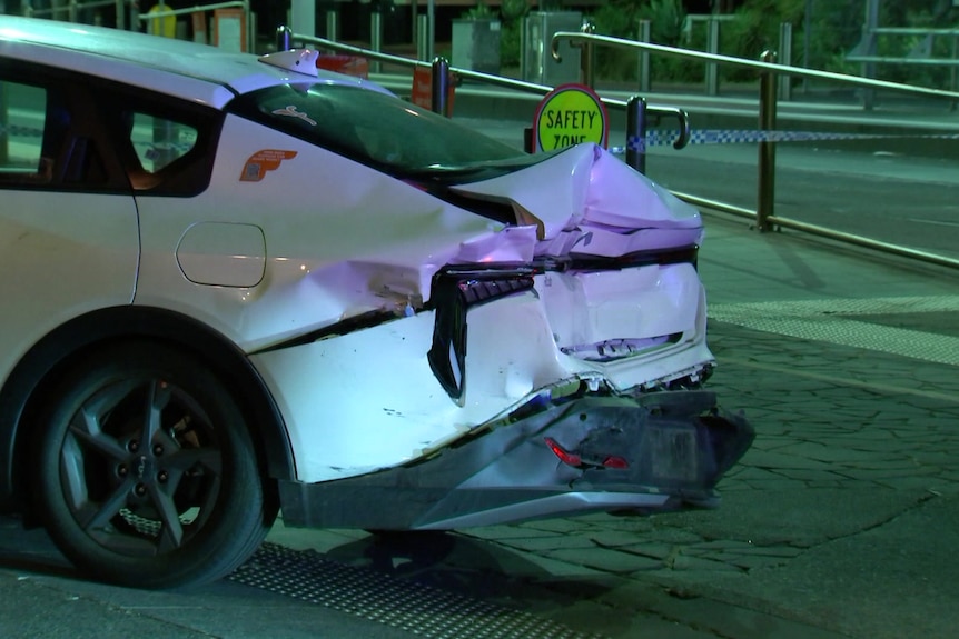 A damaged rear of a white car.