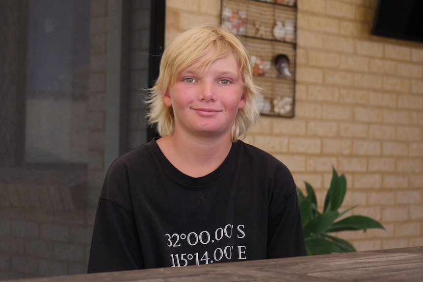 A smiling Rhys looks at the camera