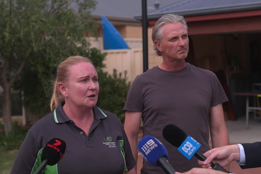 A woman and her husband are speaking to media 