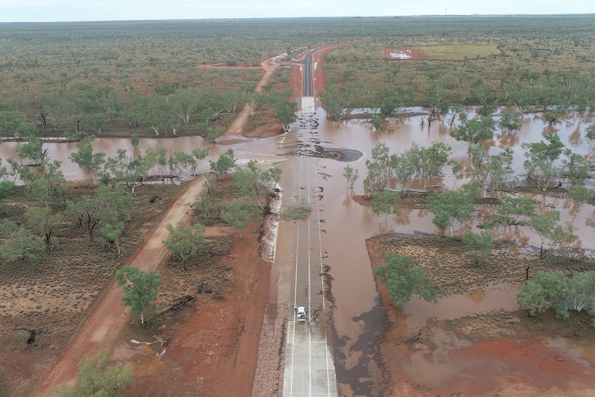 Aerial view of an outback road that has been flooded.