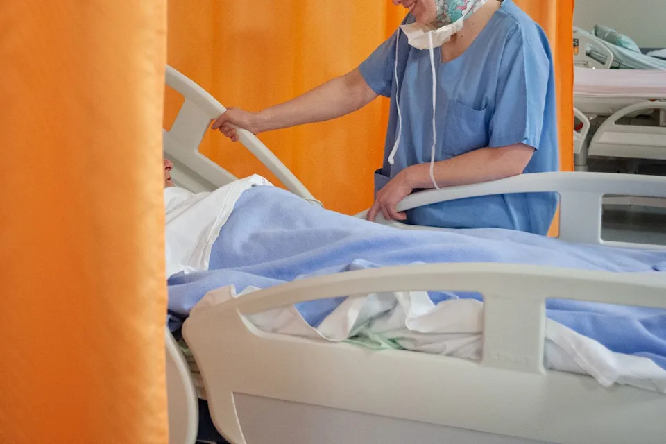 A nurse attending to a patient in a hospital room (stock image). Pascal Bachelet/BSIP/Universal Images Group via Getty