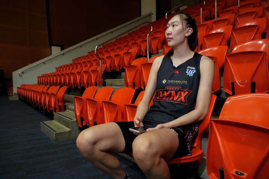 Han Xu sits courtside.