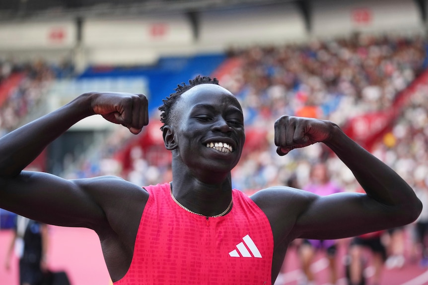 Gout Gout flexes after winning a race.