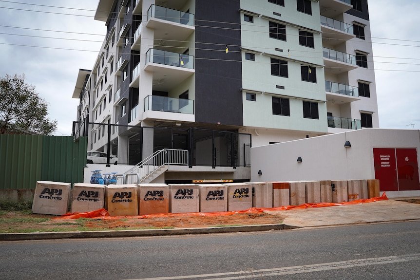 Cement bollards are lined up to protect buildings from flooding