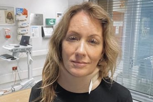 Abigail Boyd in a hospital room with a neck brace on.