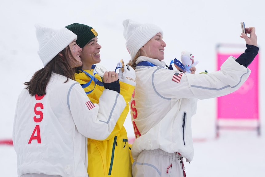 Jakara Anthony and her fellow medallists take a selfie on the medium podium.