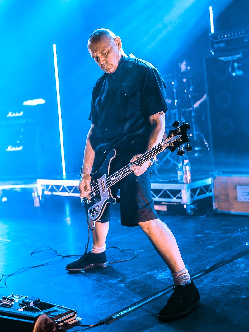 Man plays bass guitar on a stage