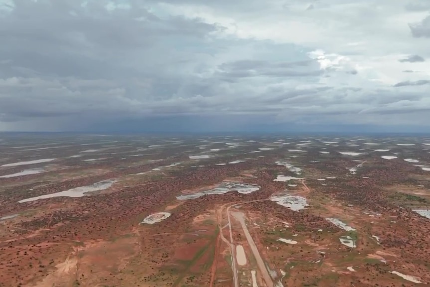 Huge puddles in a vast area of the outback, as seen from above.