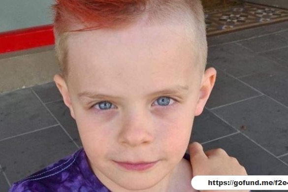 Cooper, a young boy with blue eyes and died red hair.