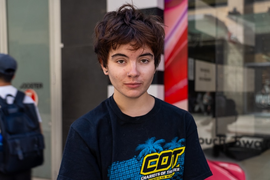 A teenage boy with dark hair and a t-shirt.