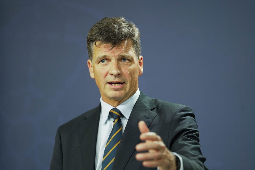 An older man wearing a suit gives an impassioned speech.