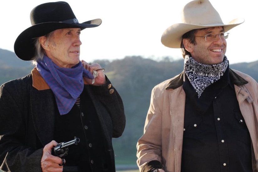 Two men dressed as cowboys.