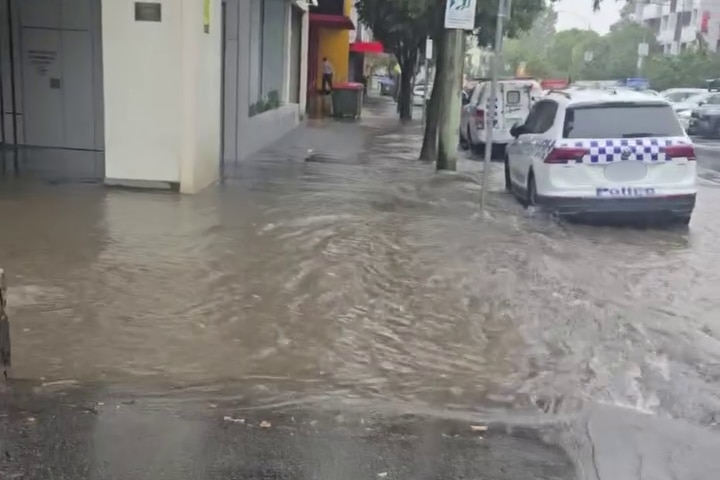 A large pool of water outside the North Melbourne police station.