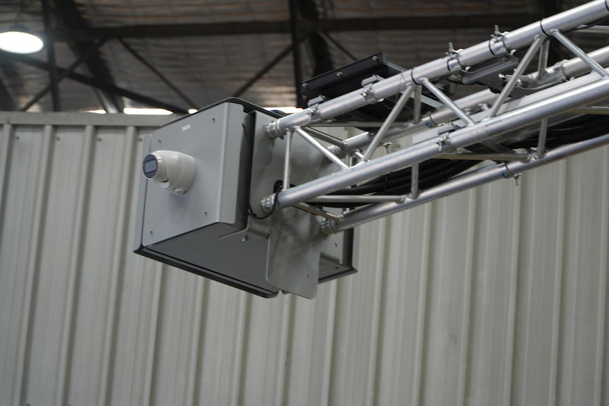 A close-up shot of a new road safety camera on the end of a metal arm.