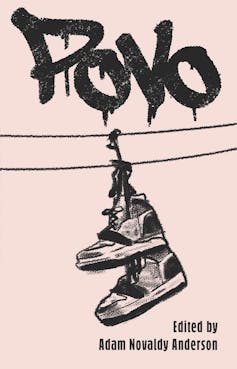 A book cover with graffiti and shoes hanging from a power line