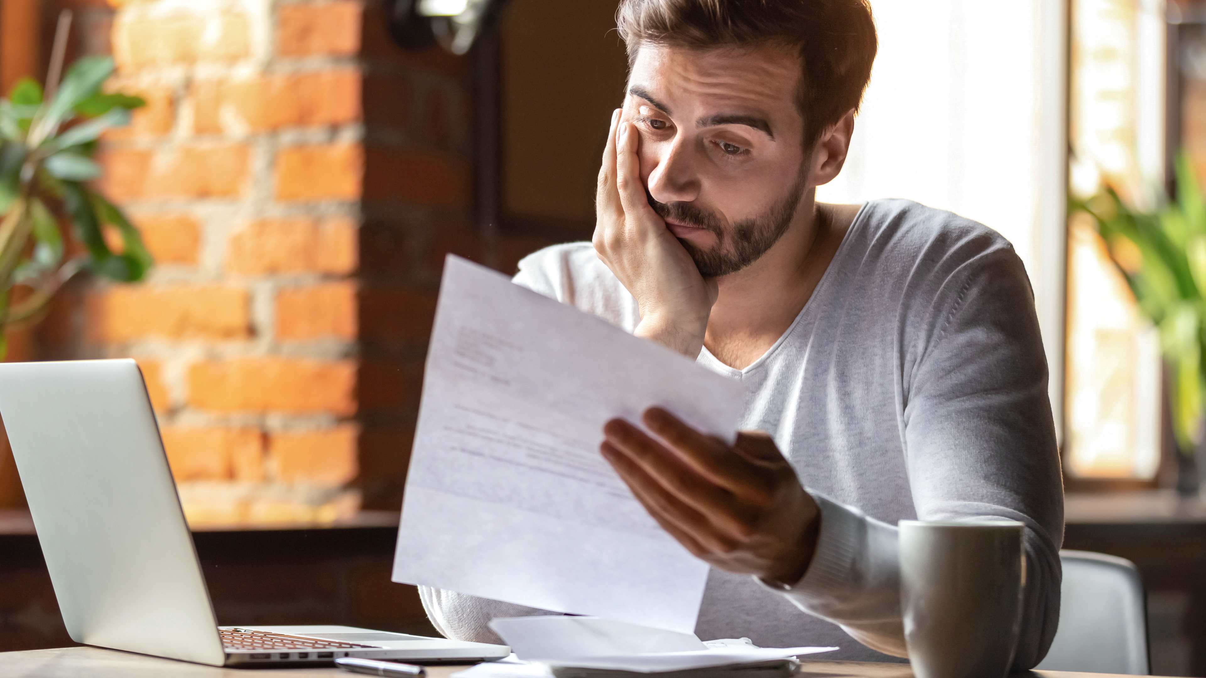 Man looks upset while reading letter