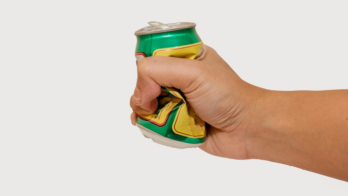 hand holding crushed can
