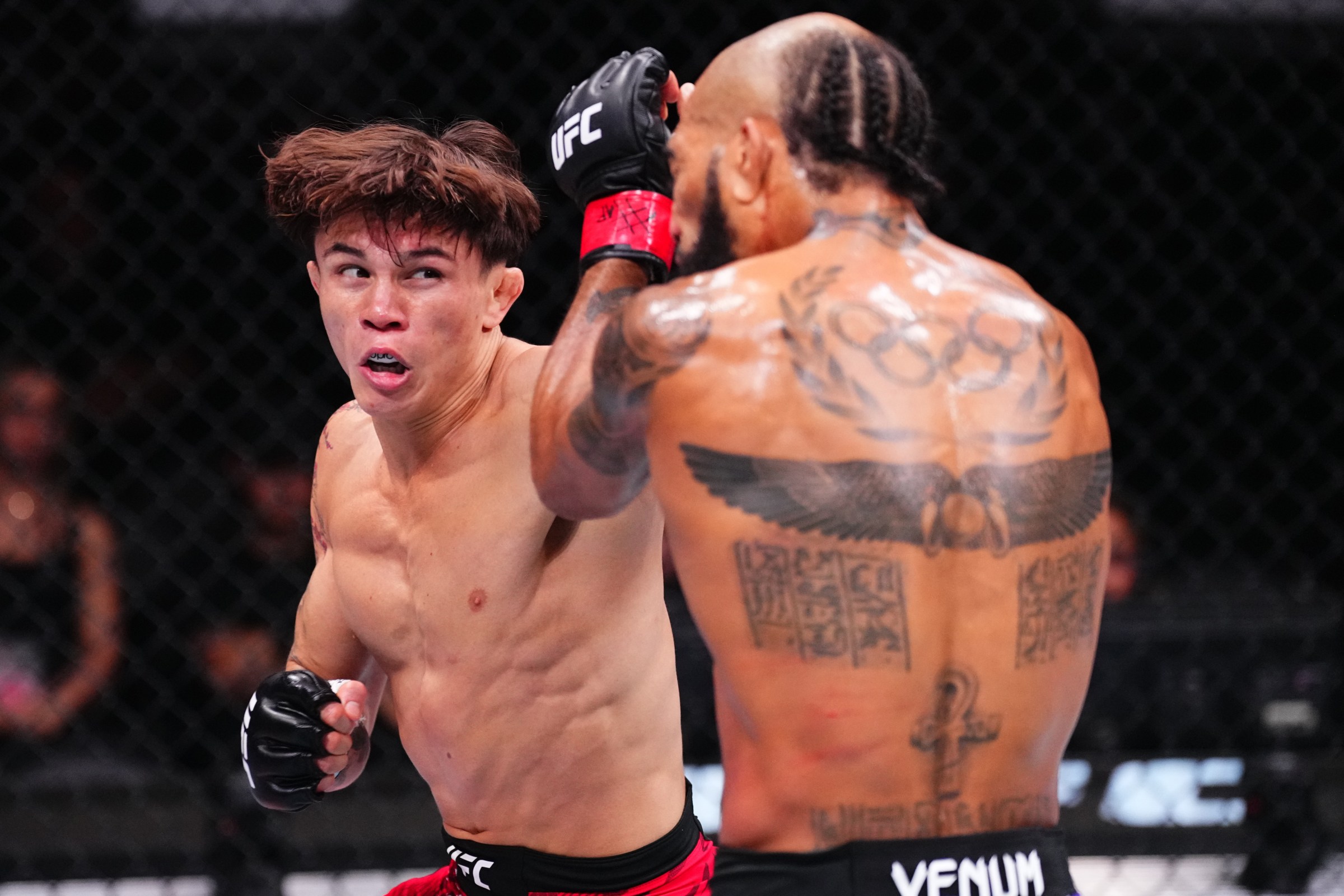 SHANGHAI, CHINA - AUGUST 23: (L-R) Lone’er Kavanagh of England punches Charles Johnson in a flyweight fight during the UFC Fight Night event at Shanghai Indoor Stadium on August 23, 2025 in Shanghai, China. (Photo by Jeff Bottari/Zuffa LLC)