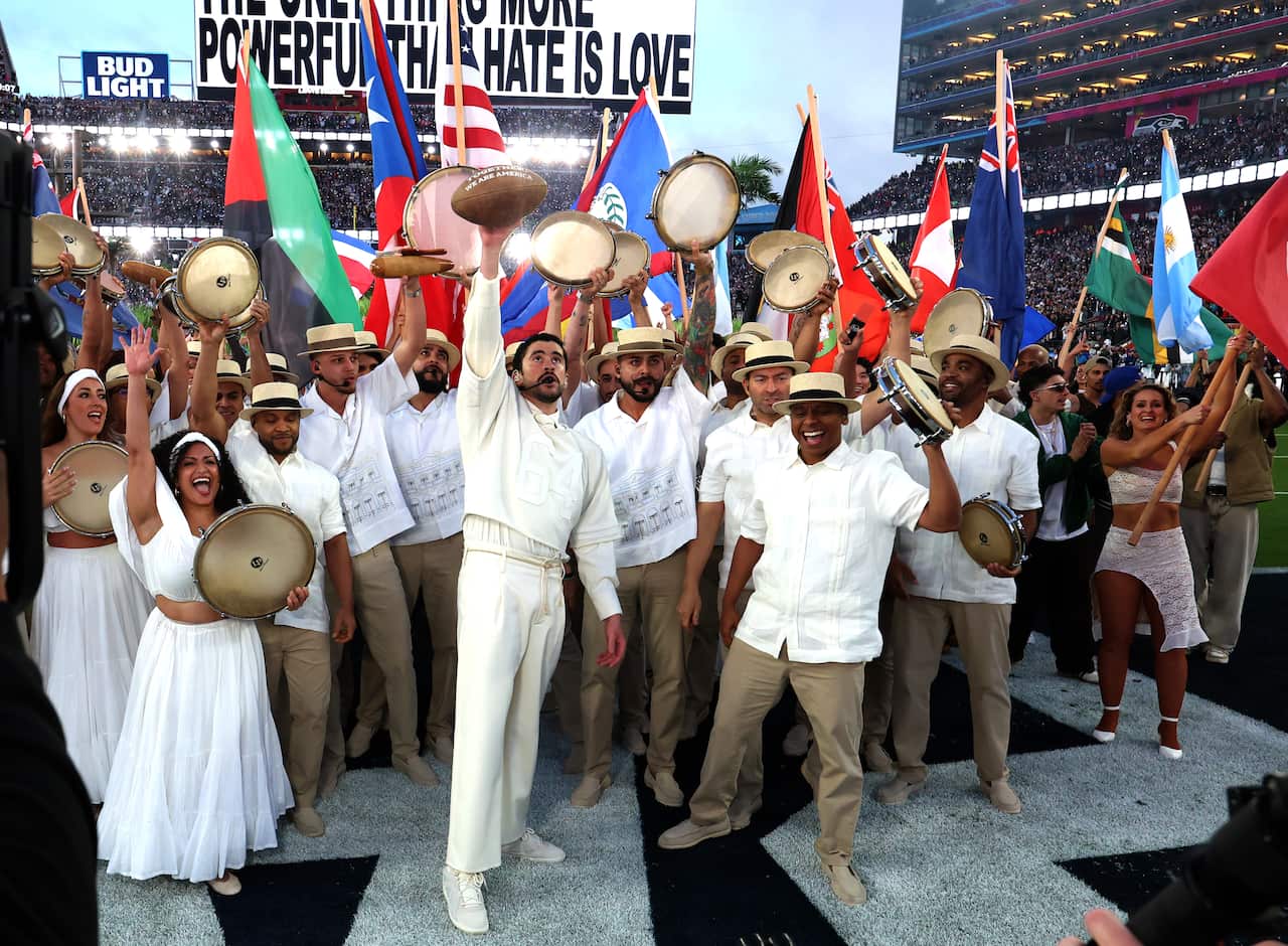 A group of people dressed in white waving flags and tambourines.