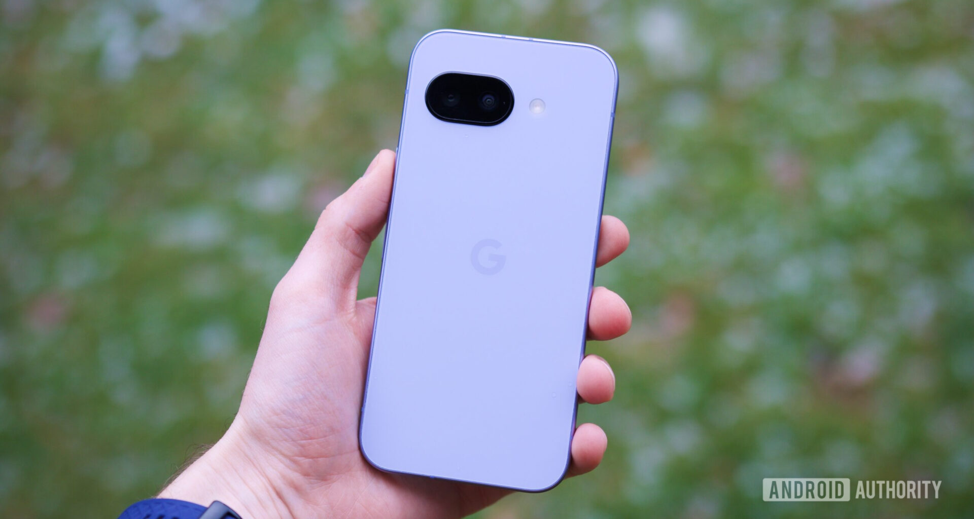 Someone holding the Pixel 9a, showing the back of the phone.