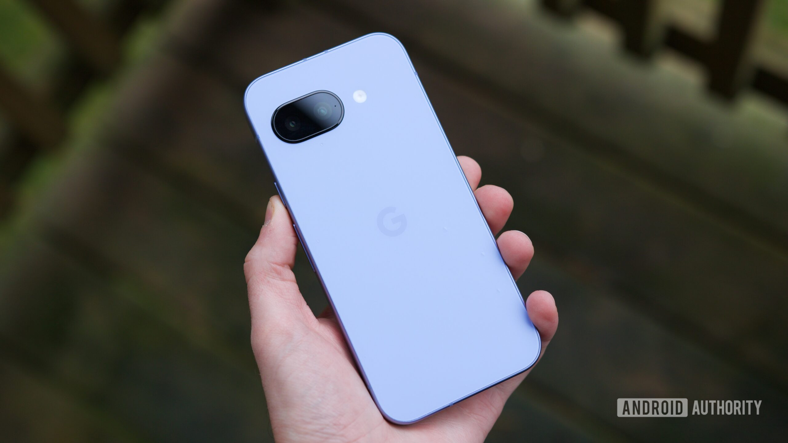 Someone holding the Pixel 9a, showing the back of the phone.