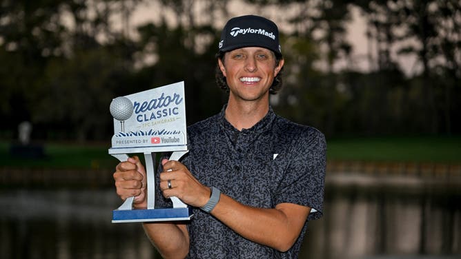 Grant Horvat celebrates with the trophy on the 17th hole green after winning the Creator Classic prior to THE PLAYERS Championship 2025 at TPC Sawgrass on March 12, 2025 in Ponte Vedra Beach, Florida.