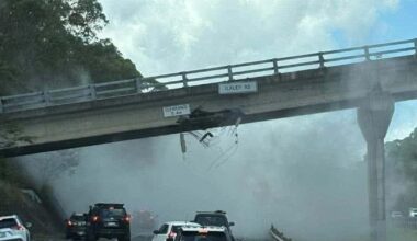 Major highway closed after truck carrying excavator hits overhead bridge