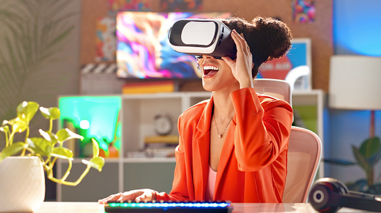 A woman wears a VR headset in a colorful room