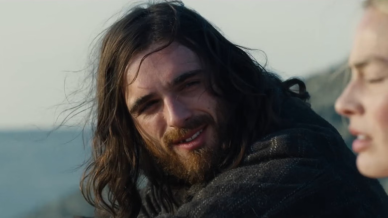 Heathcliff with long hair talking to Cathy on the hilltop in Wuthering Heights