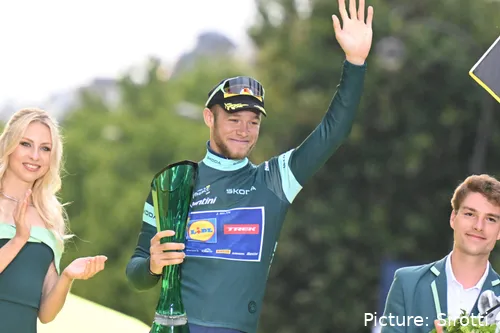 Jonathan Milan on the final podium of the 2025 Tour de France in Paris, celebrating his Green Jersey win