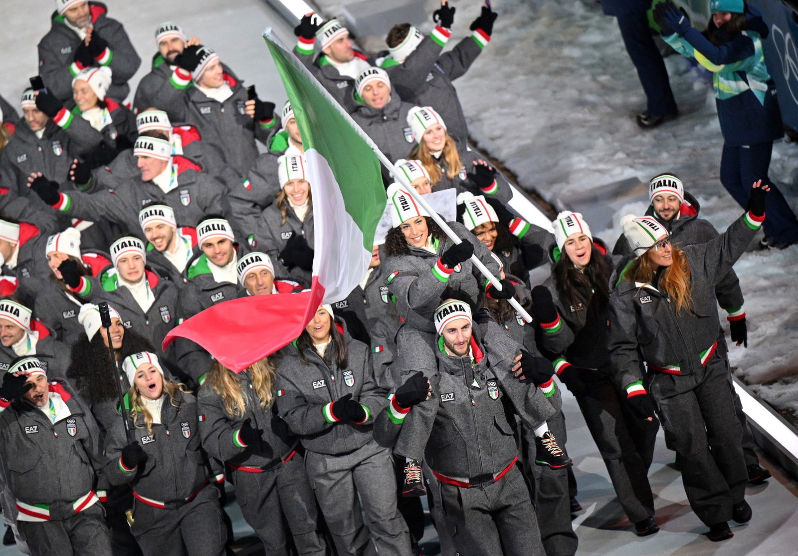 Flagbearers Amos Mosaner and Federica Brignone of Team Italy enter the parade during the opening ceremony of the Milano Cortina 2026 Winter Olympics at Piazza Dibona on February 06, 2026 in Cortina d'Ampezzo, Italy.