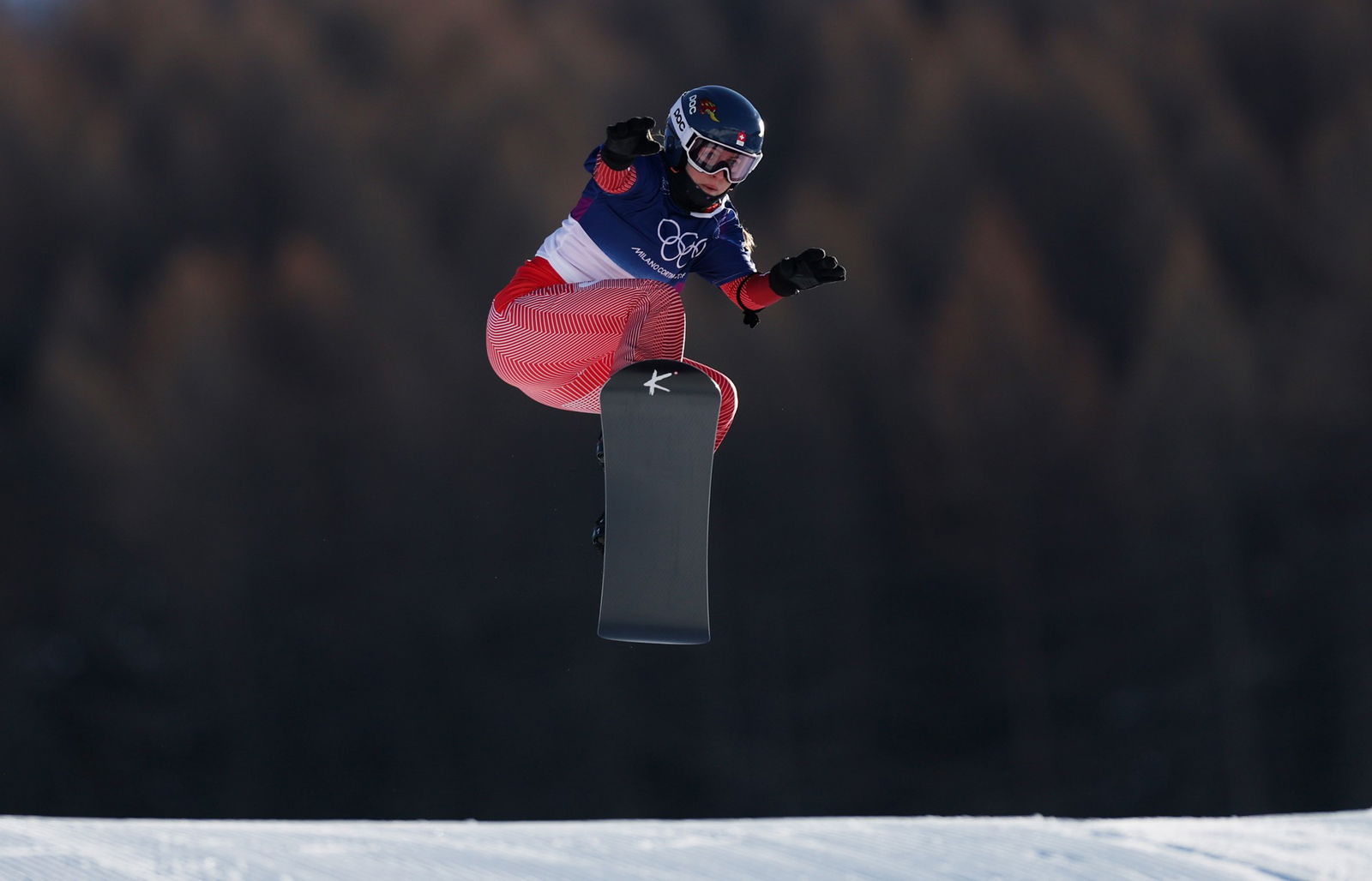 A competitor in the women's snowboard cross.