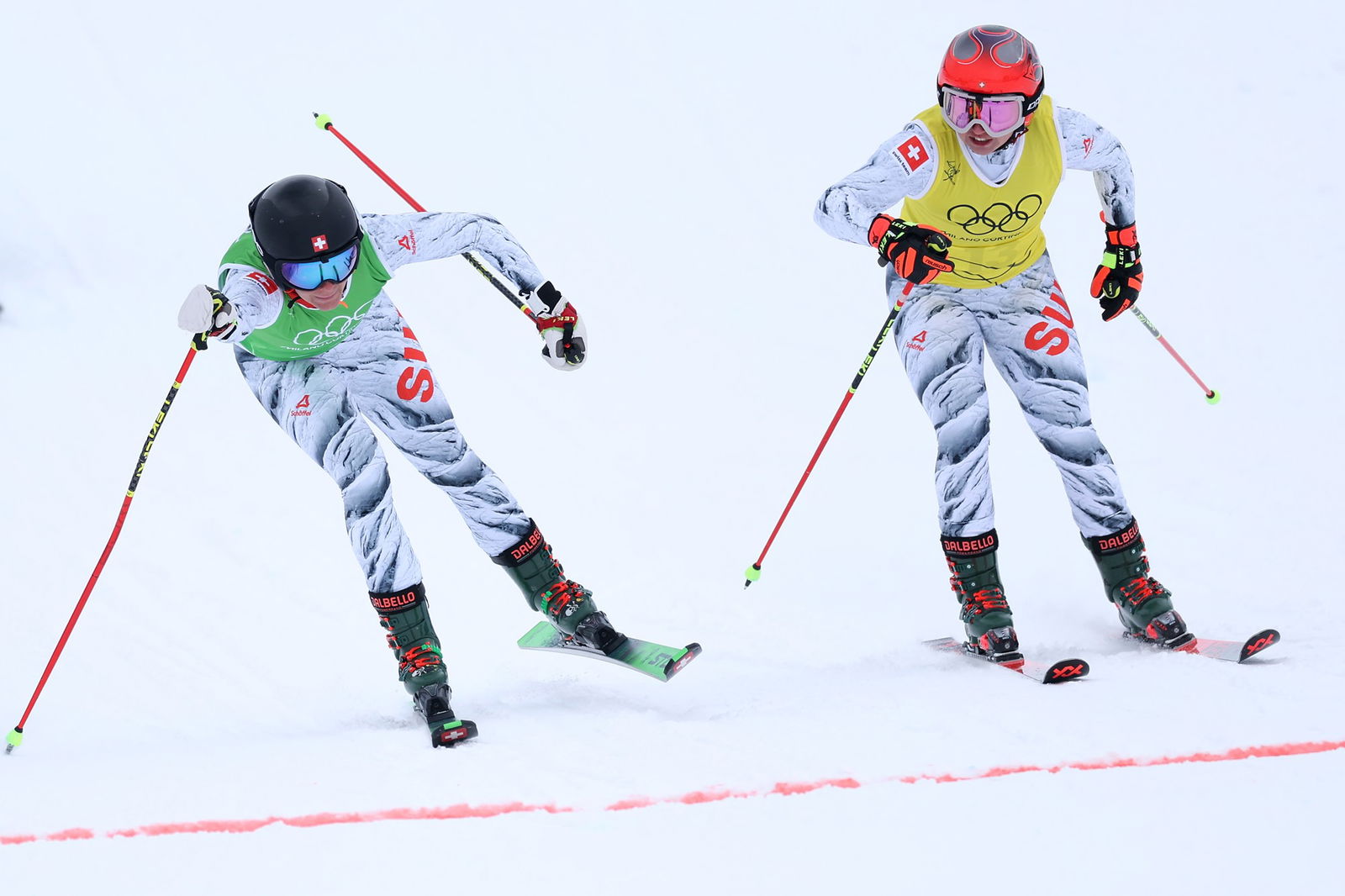Talina Gantenbein of Team Switzerland and Sixtine Cousin of Team Switzerland approach the finish line in the Women's Ski Cross Quarterfinals on day fourteen of the Milano Cortina 2026 Winter Olympic games at Livigno Snow Park on February 20, 2026 in Livigno, Italy.