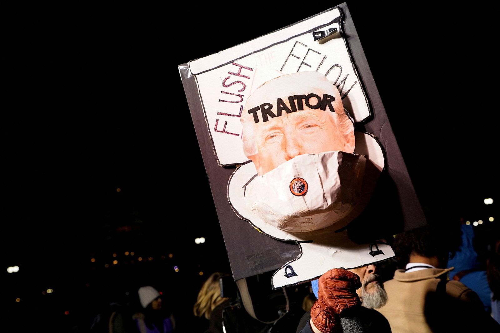 A person holds an anti-Trump sign during the "People's State of the Union" event