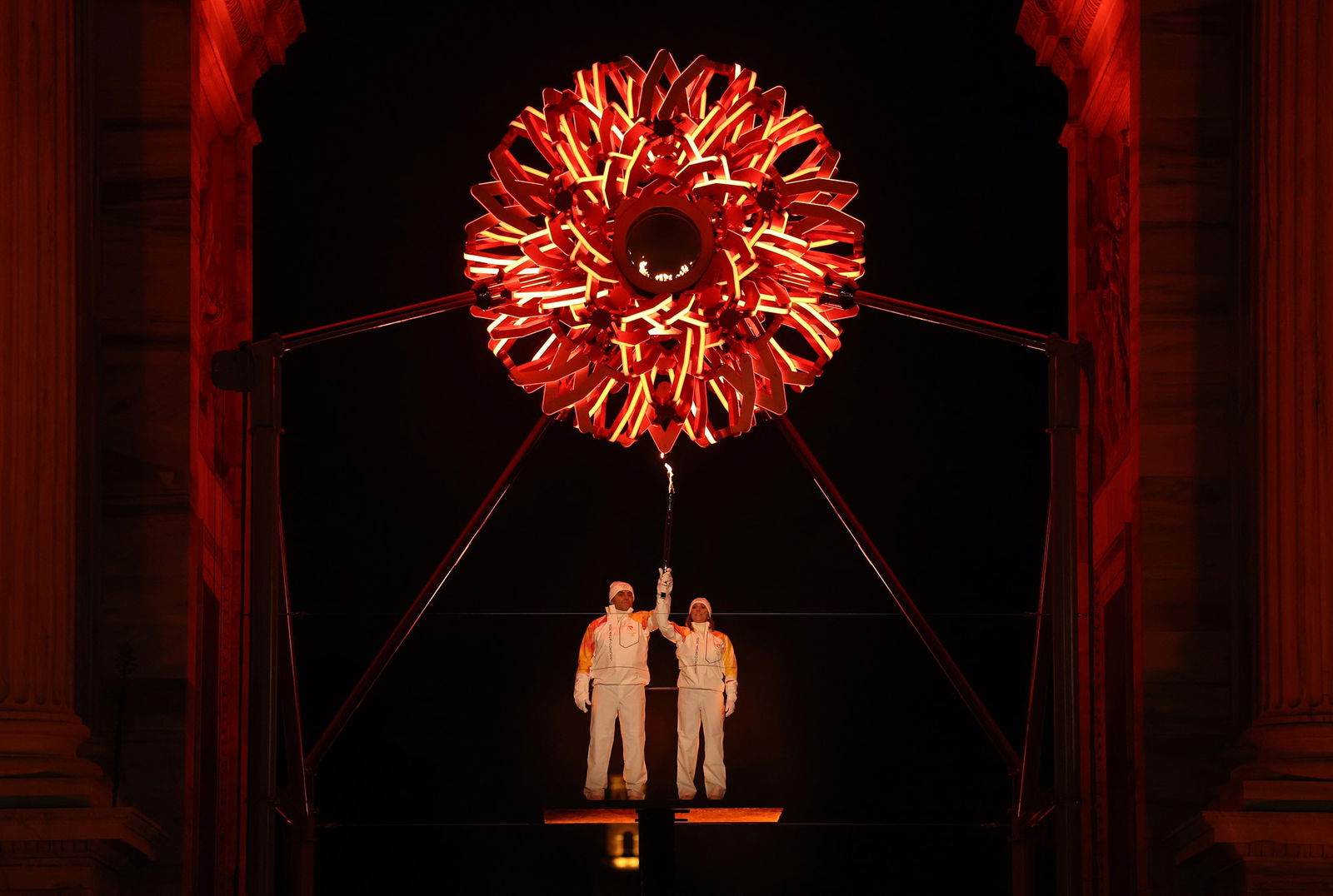 Torchbearers Deborah Compagnoni and Alberto Tomba lights the Olympic cauldron at the Arco della Pace during the opening ceremony of the Milano Cortina 2026 Winter Olympics on February 06, 2026 in Milan, Italy. 