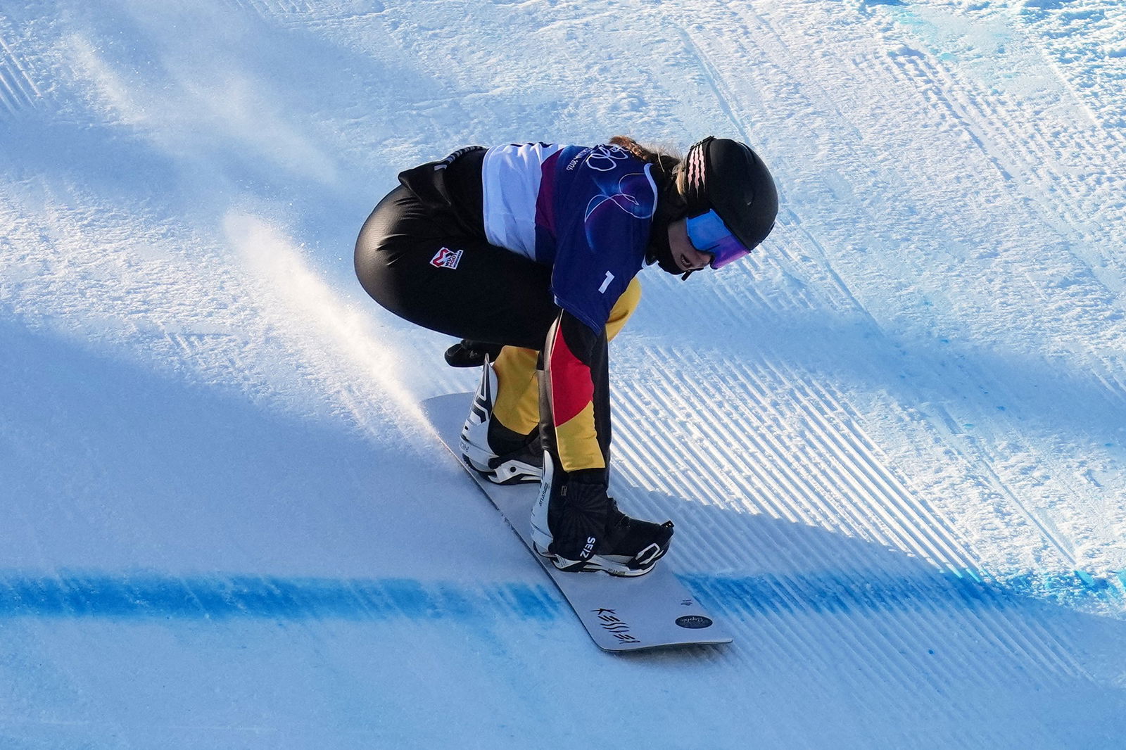 A competitor in the women's snowboard cross.