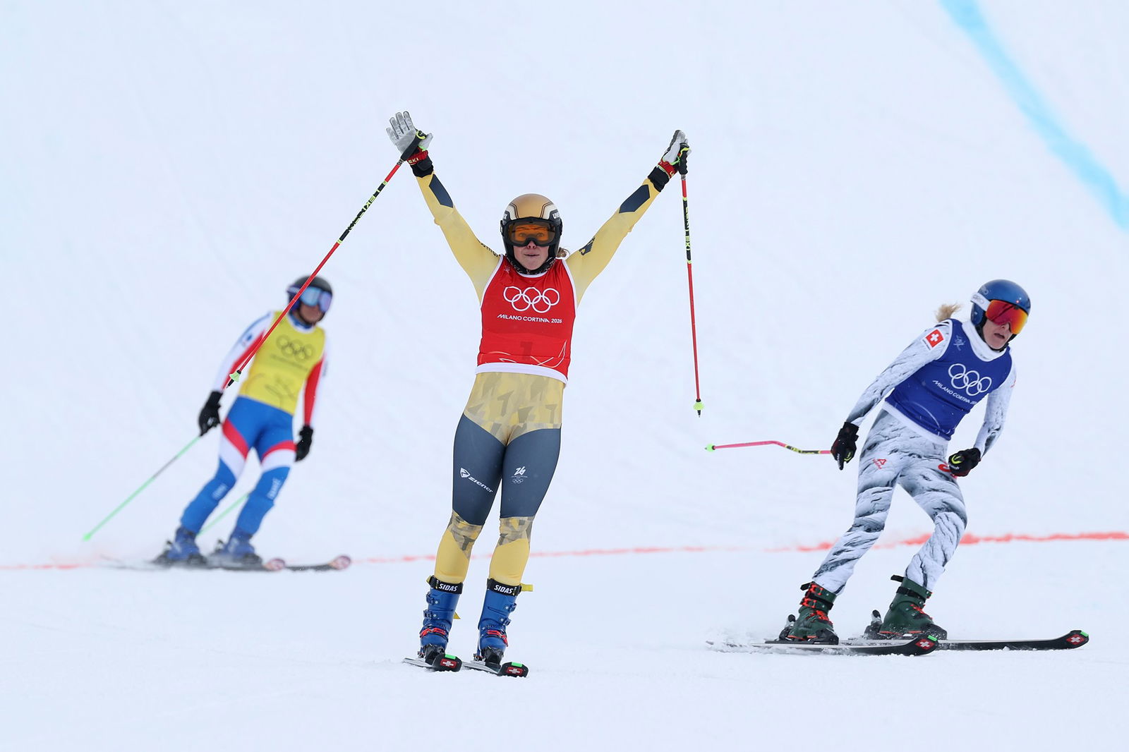 LIVIGNO, ITALY - FEBRUARY 20: Gold medalist Daniela Maier of Team Germany celebrates after crossing the finish line followed by Silver medalist Fanny Smith of Team Switzerland and fourth placed Marielle Berger Sabbatel of Team France in the Women's Ski Cross Big Final on day fourteen of the Milano Cortina 2026 Winter Olympic games at Livigno Snow Park on February 20, 2026 in Livigno, Italy. 