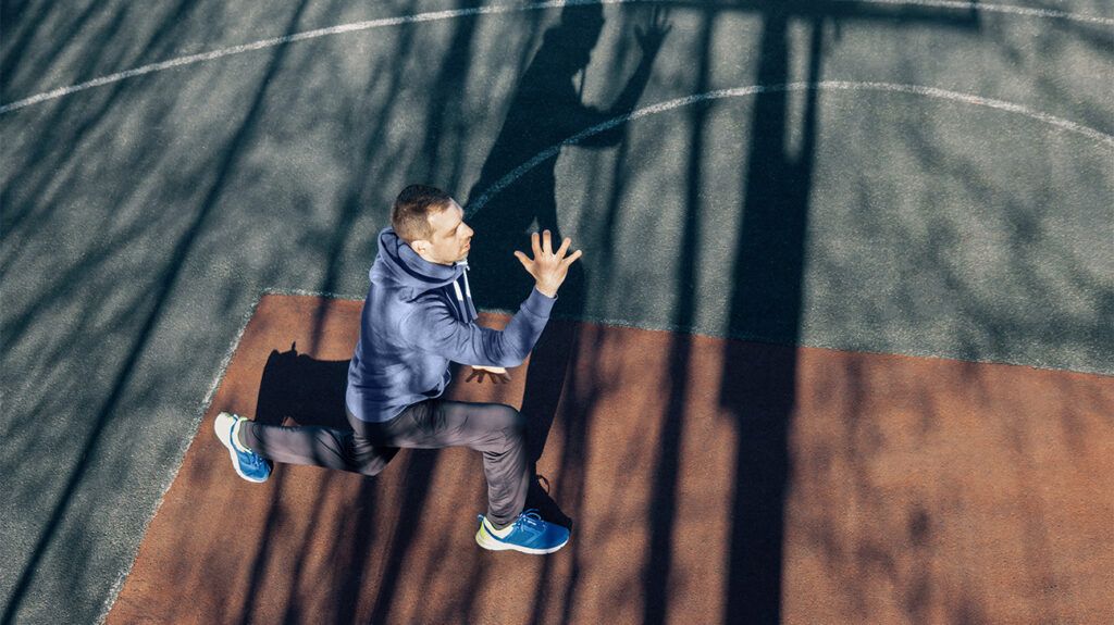 A person exercising in a sports court.