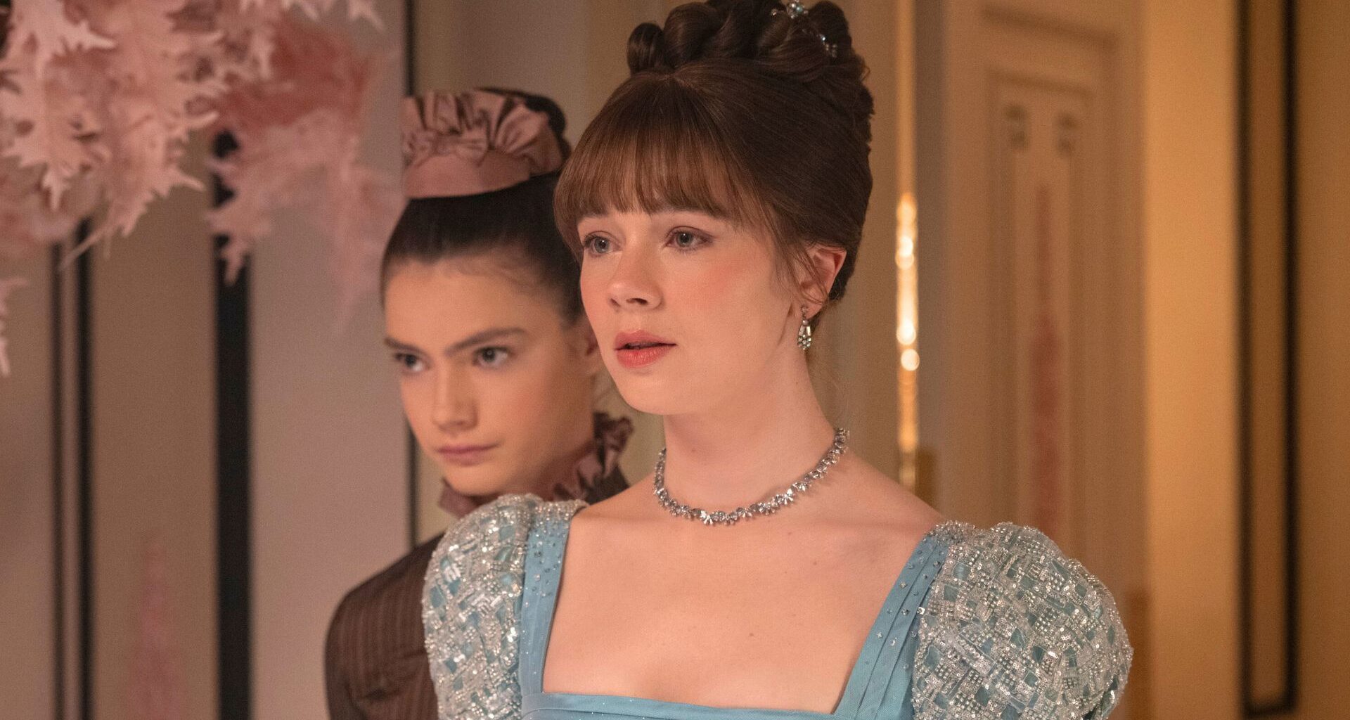 Hyacinth rests her chin on Eloise's shoulder