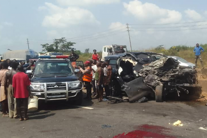 People gather at the scene of a vehicle accident in Lagos, Nigeria.