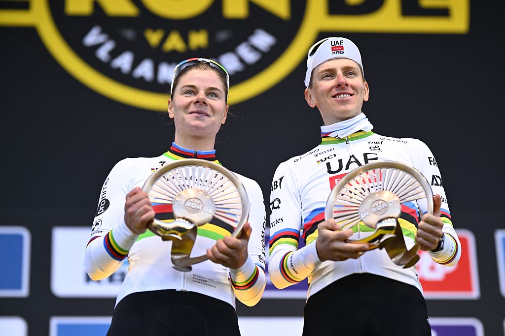 Belgian Lotte Kopecky of SD Worx-Protime and Slovenian Tadej Pogacar of UAE Team Emirates celebrate on the podium after winning the 'Ronde van Vlaanderen/ Tour des Flandres/ Tour of Flanders' one day cycling race, in Oudenaarde, Sunday 06 April 2025.BELGA PHOTO JASPER JACOBS (Photo by JASPER JACOBS / BELGA MAG / Belga via AFP)