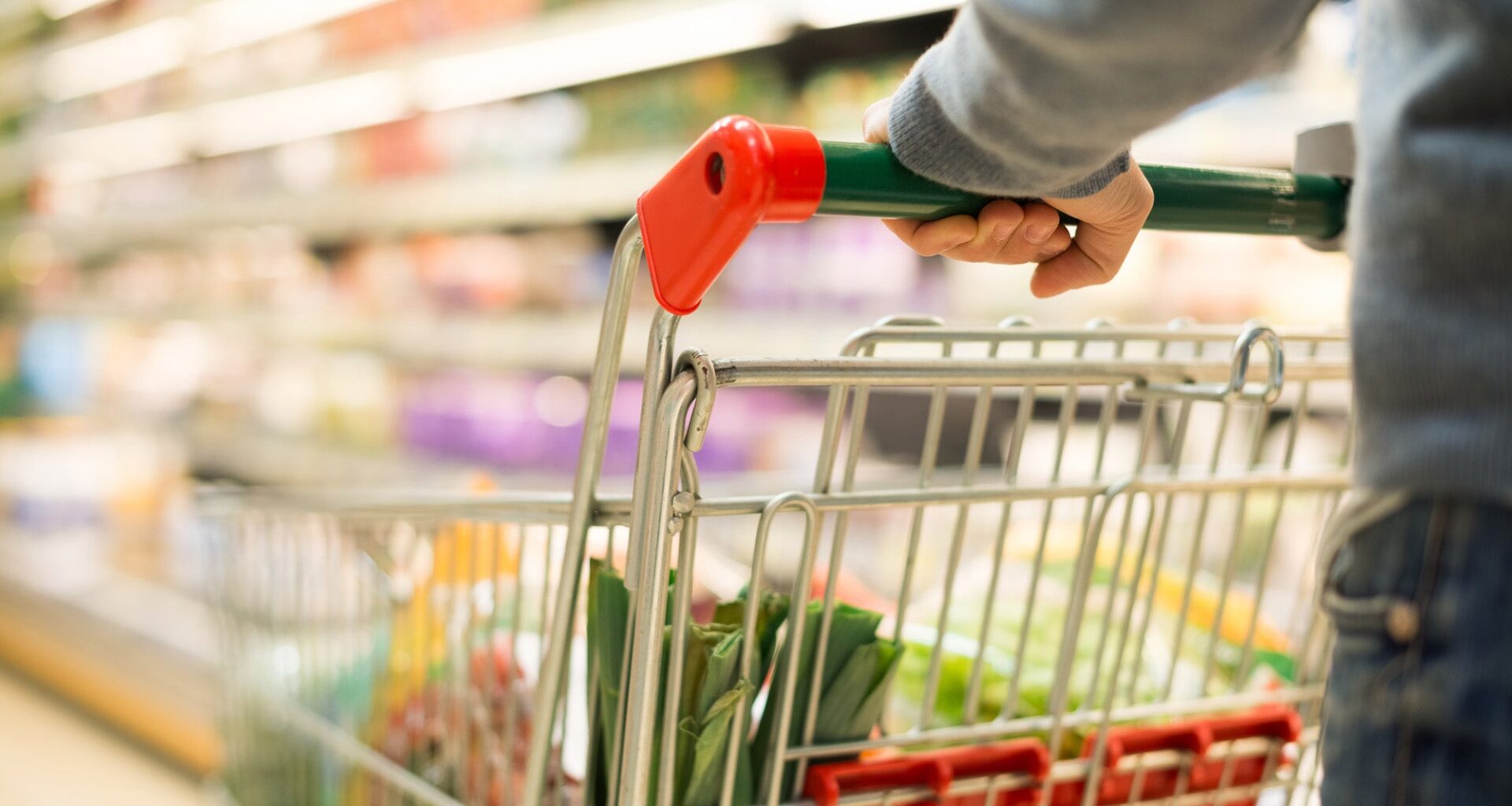 man pushing grocery cart