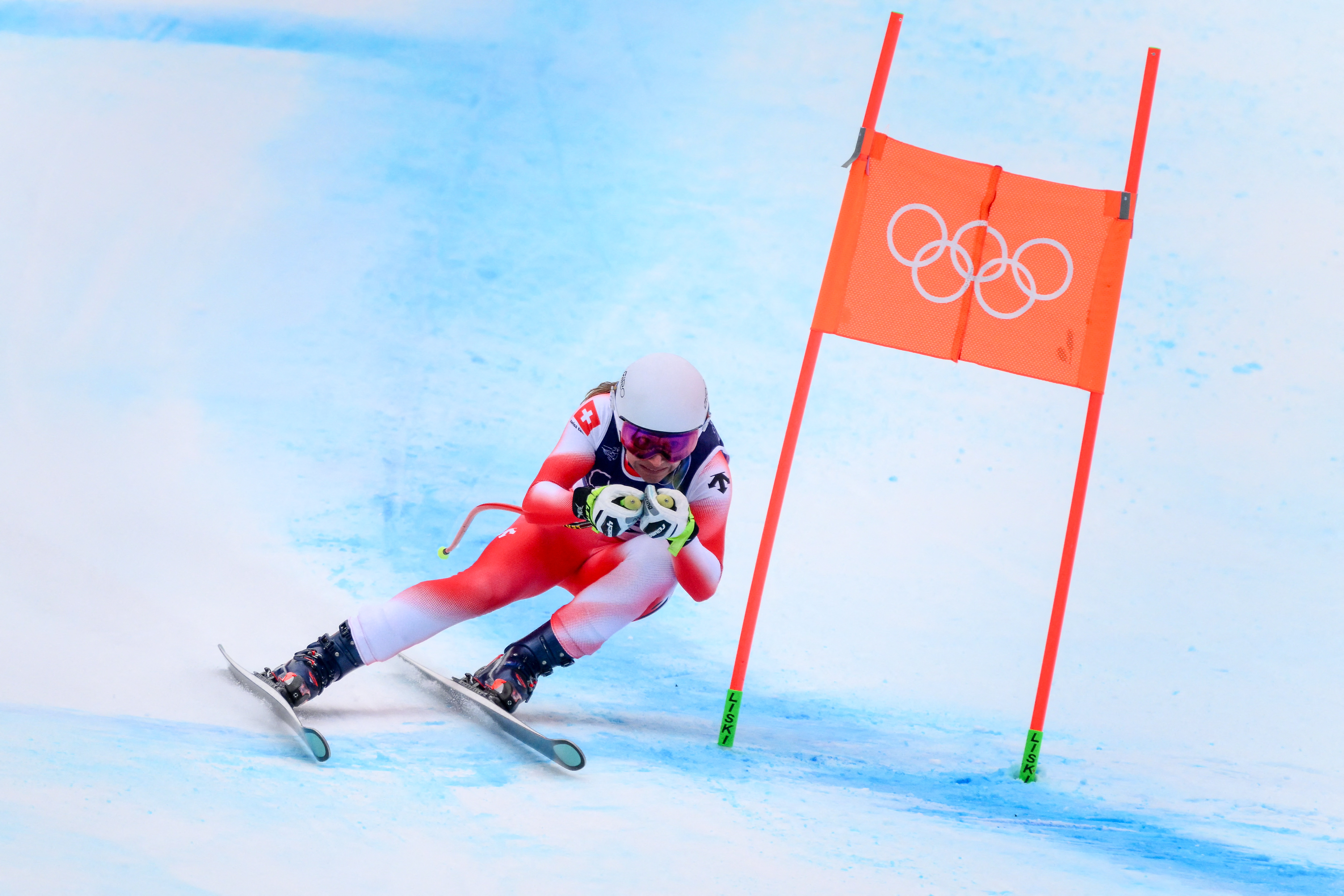 A skier makes a turn around course markers in the slalom event